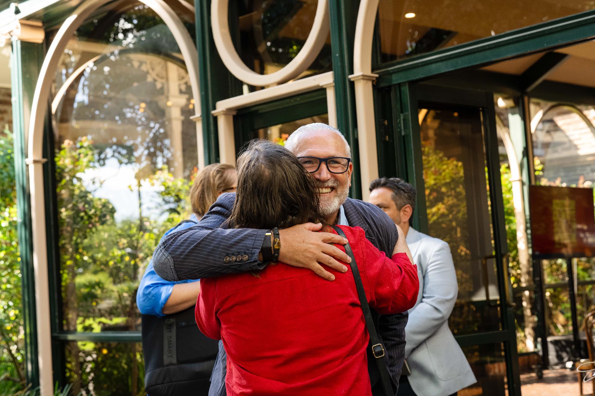 Two ACAW supporters embracing at the launch event